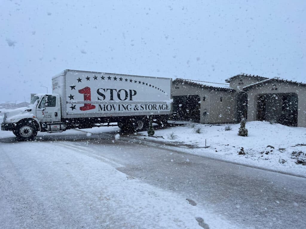 One Stop Moving & Storage truck on a snowy road during a long-distance move