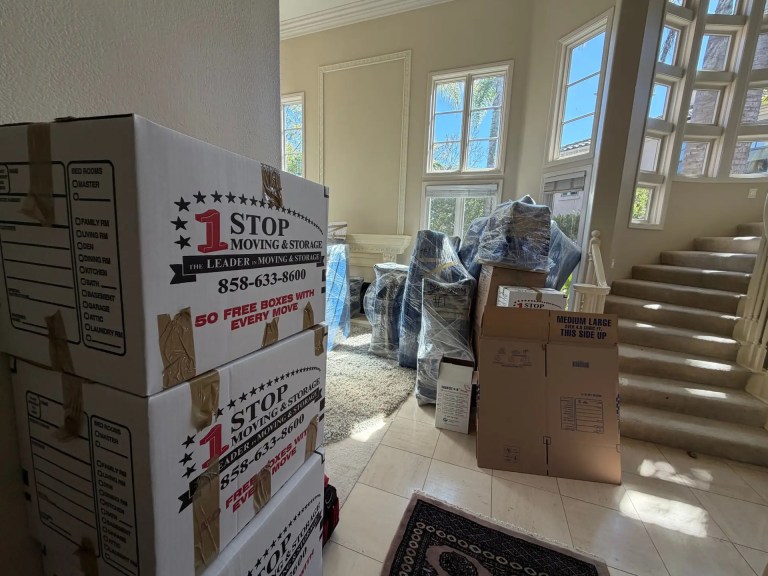 One Stop Moving & Storage boxes packed and labeled in a living room