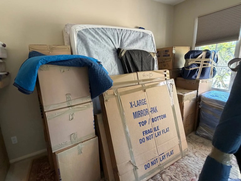 Packed moving boxes and a mirror carton ready for loading